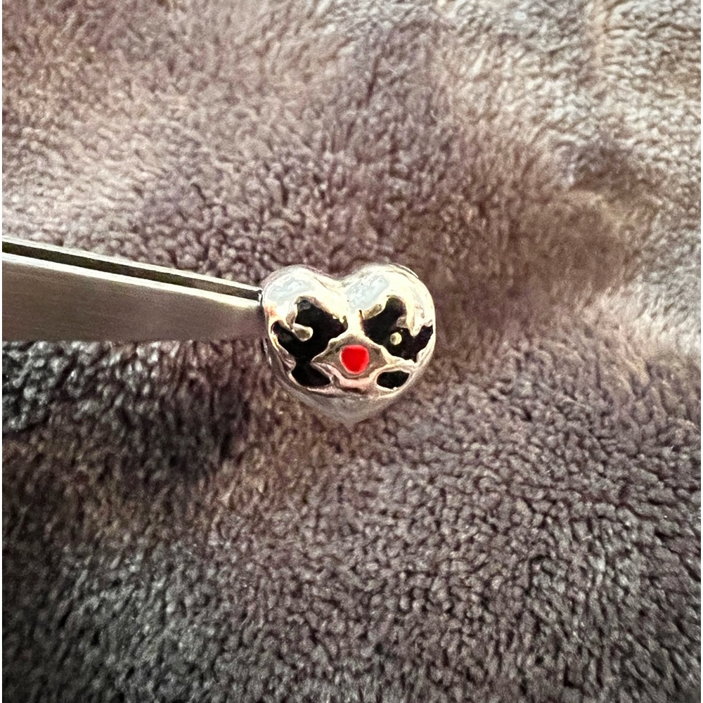 Retired Pandora Disney, “Minnie and Mickey Kiss” charm sterling silver.